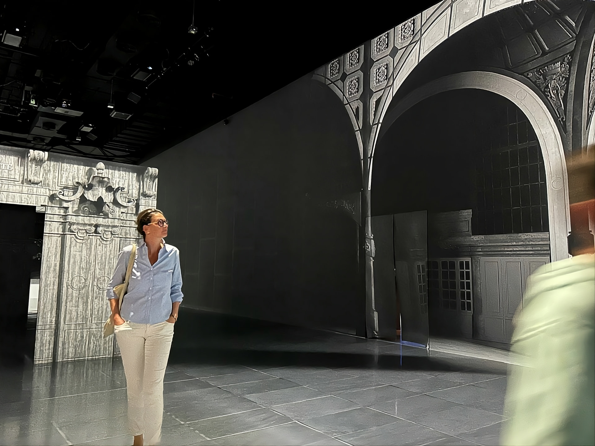 Anne Schaeflein standing among the arches of an exhibition hall