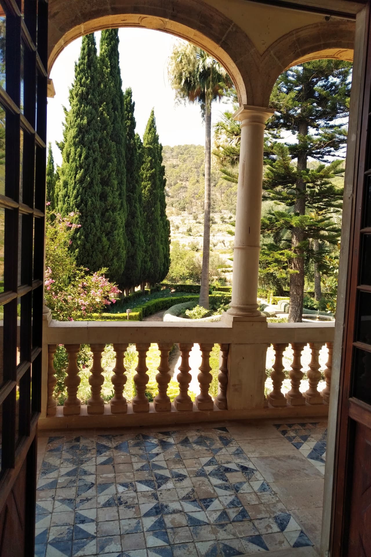 Arched doors opening onto a garden terrace